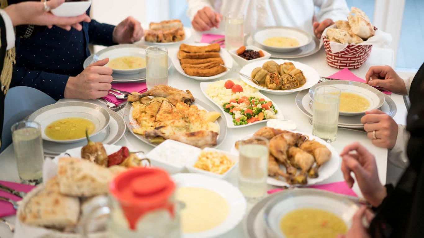 Group Sharing Traditional Meal at Festive Table