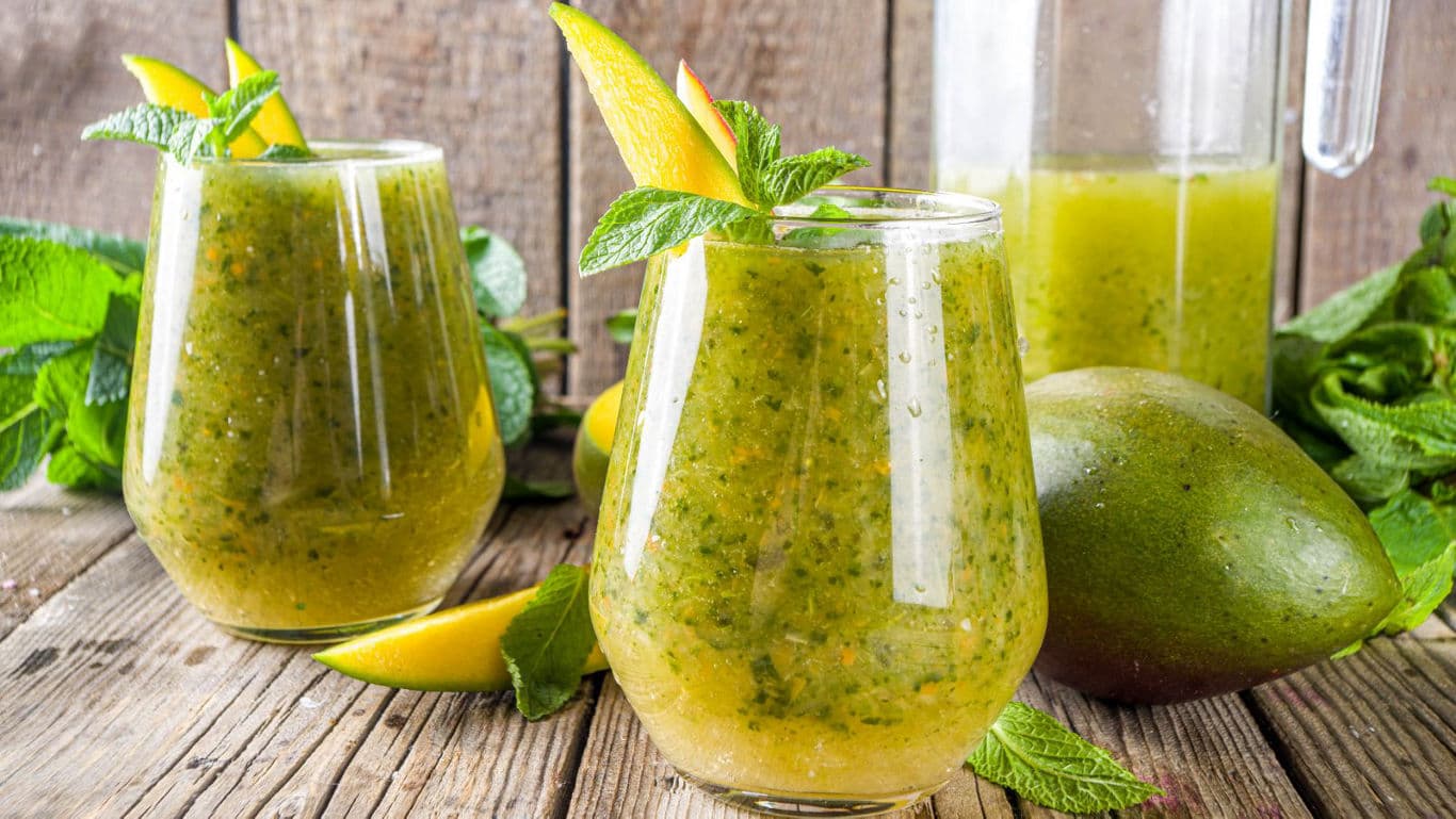 Fresh Mango Mint Smoothie in Glasses on Rustic Table