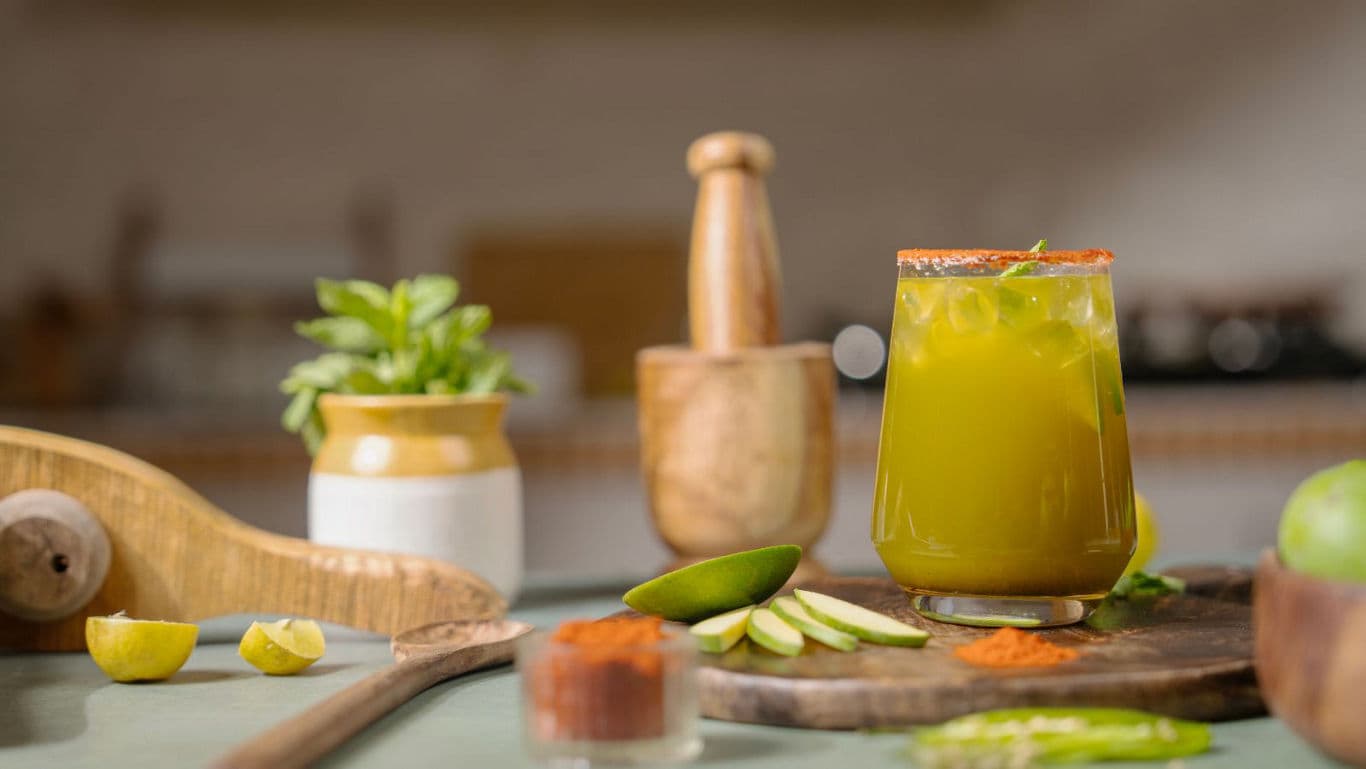 Fresh green juice with spices in kitchen