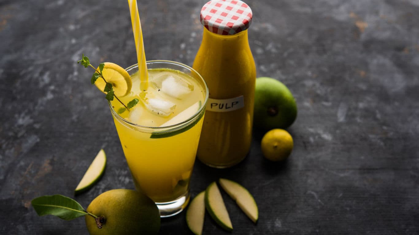 Chilled mango juice with ice and fresh fruit slices