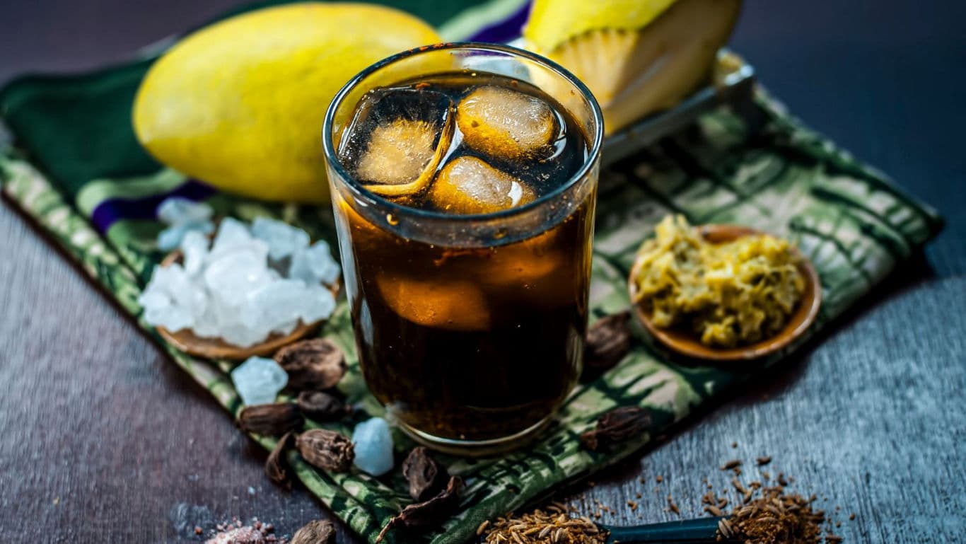 Chilled Dark Beverage with Ice and Mango