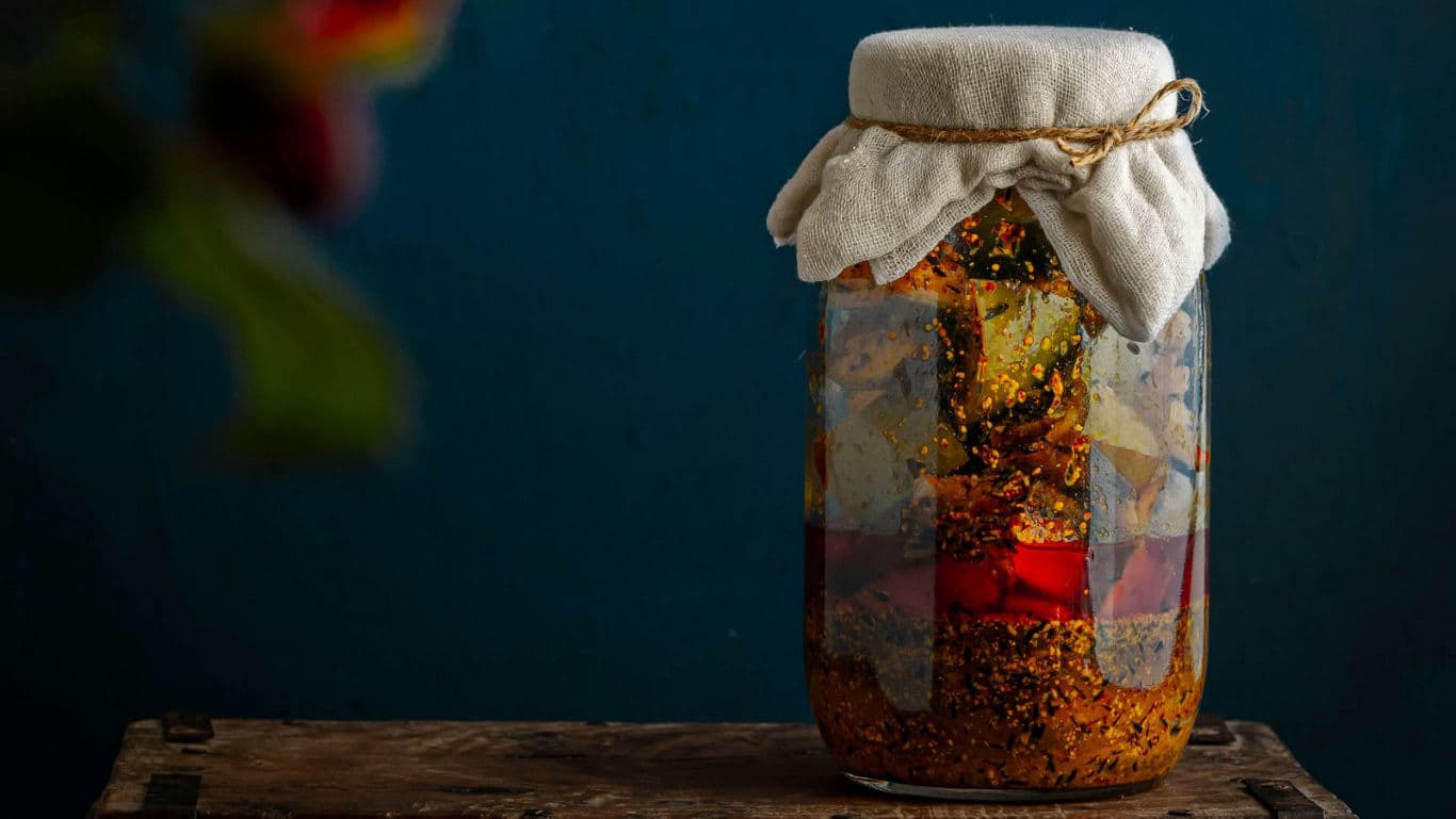 Homemade Pickled Vegetables in Glass Jar on Table