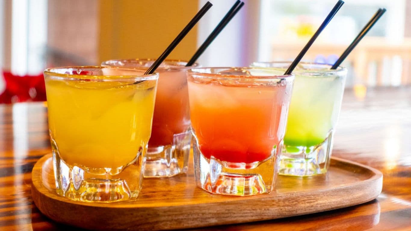 Colorful Mixed Drinks on Wooden Tray Indoors