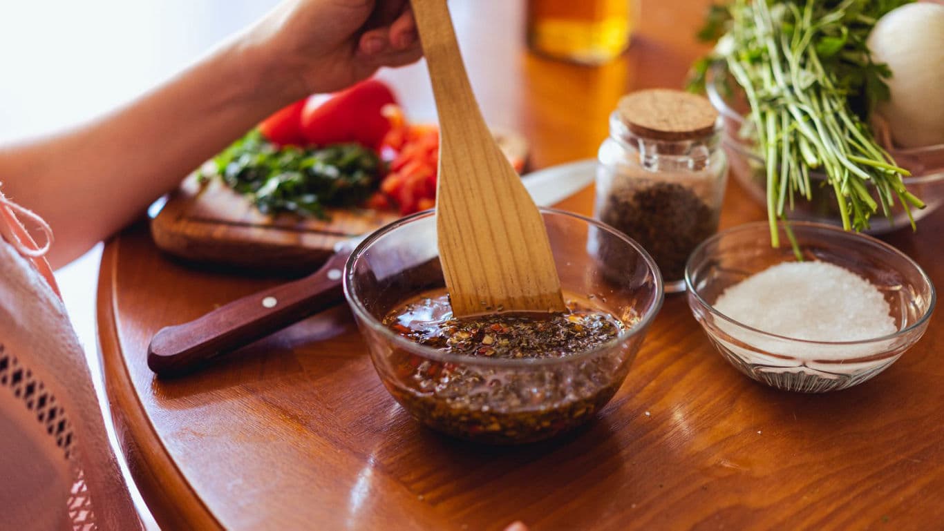 Mixing herbs and spices in glass bowl