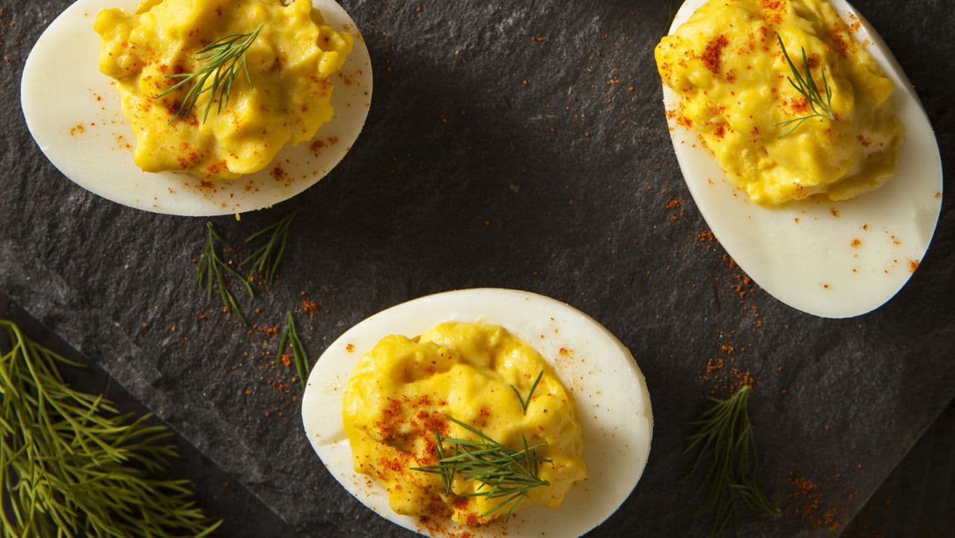 Deviled eggs with paprika and dill garnish