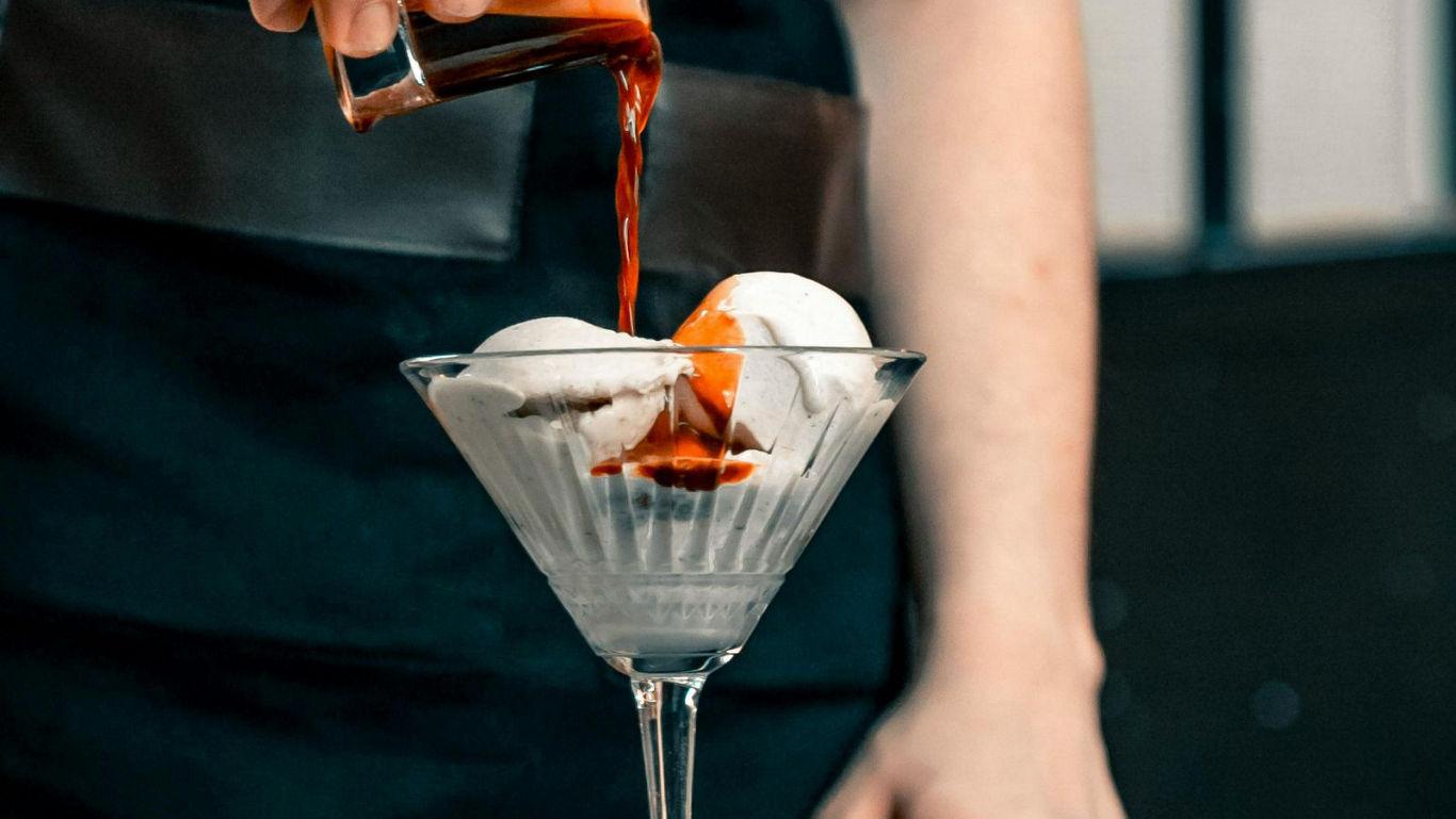 Pouring espresso over vanilla ice cream