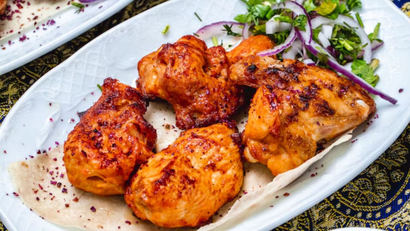 Grilled chicken pieces served with fresh salad