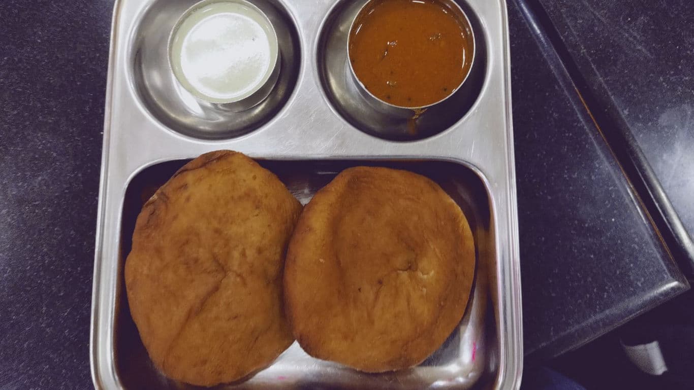 Traditional Indian meal with puris and side dishes