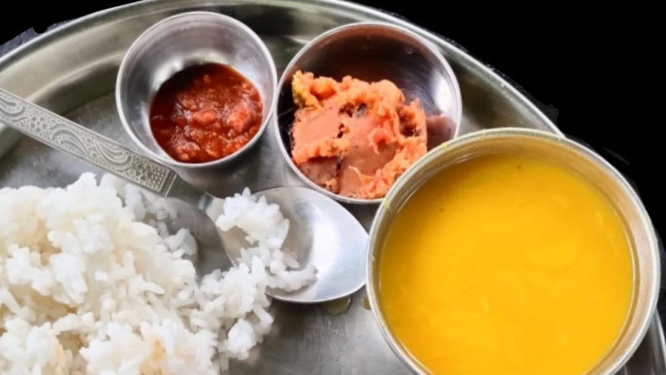 Traditional Indian meal with rice, dal, and condiments