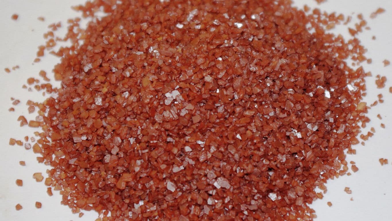 Close-up of reddish granular salt crystals