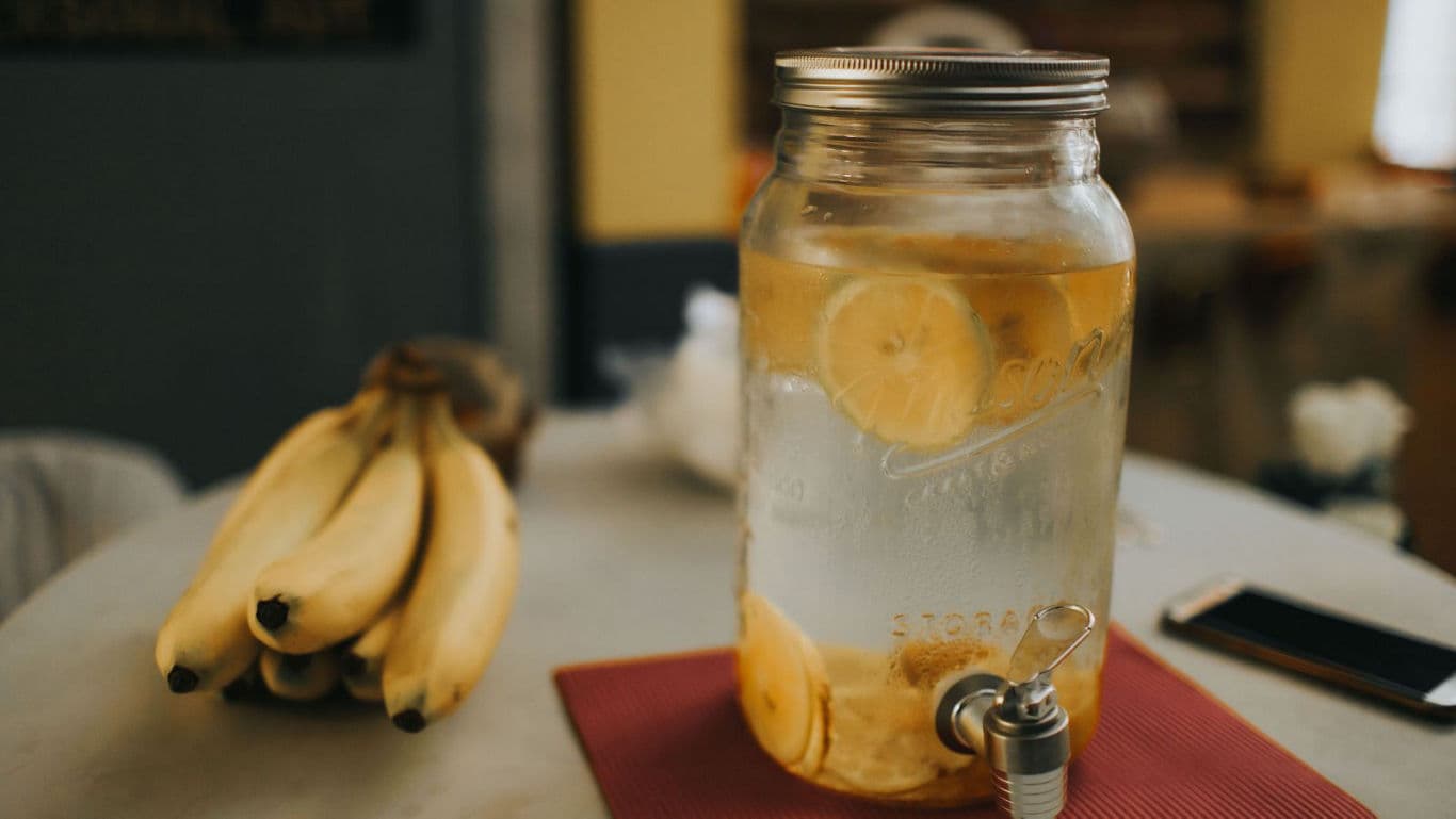 Infused lemon water in glass dispenser