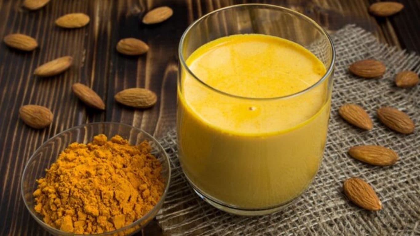 Glass of Golden Turmeric Milk with Almonds