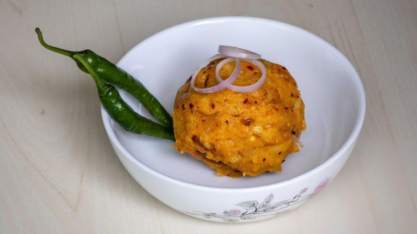 Spicy mashed dish with green chilies and onions