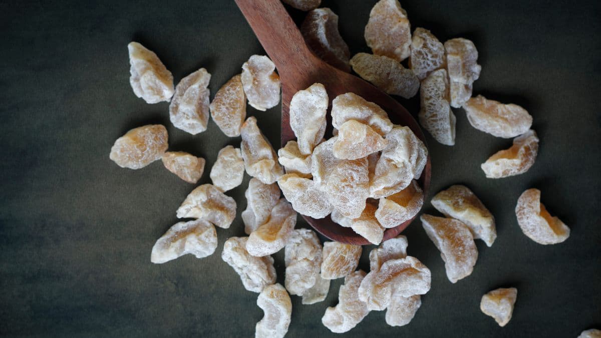 Amla candy on a wooden spoon