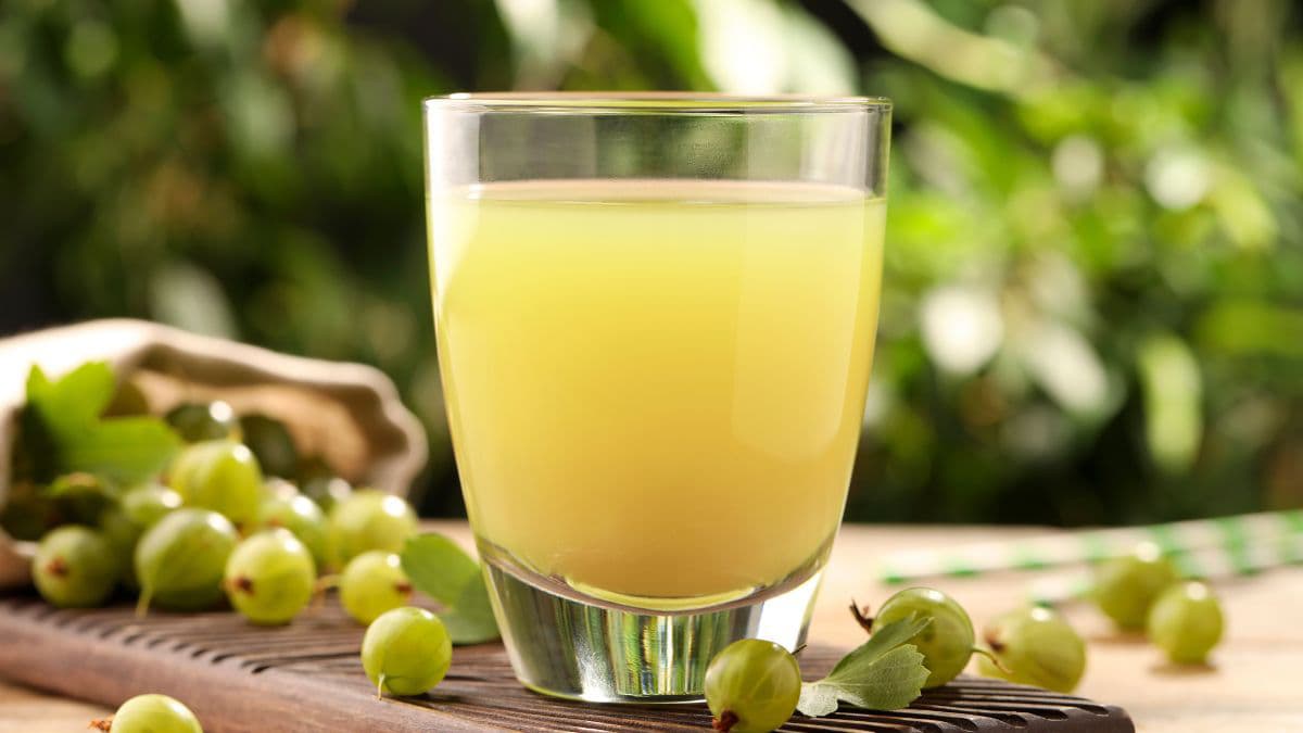 Juice glass surrounded by berries