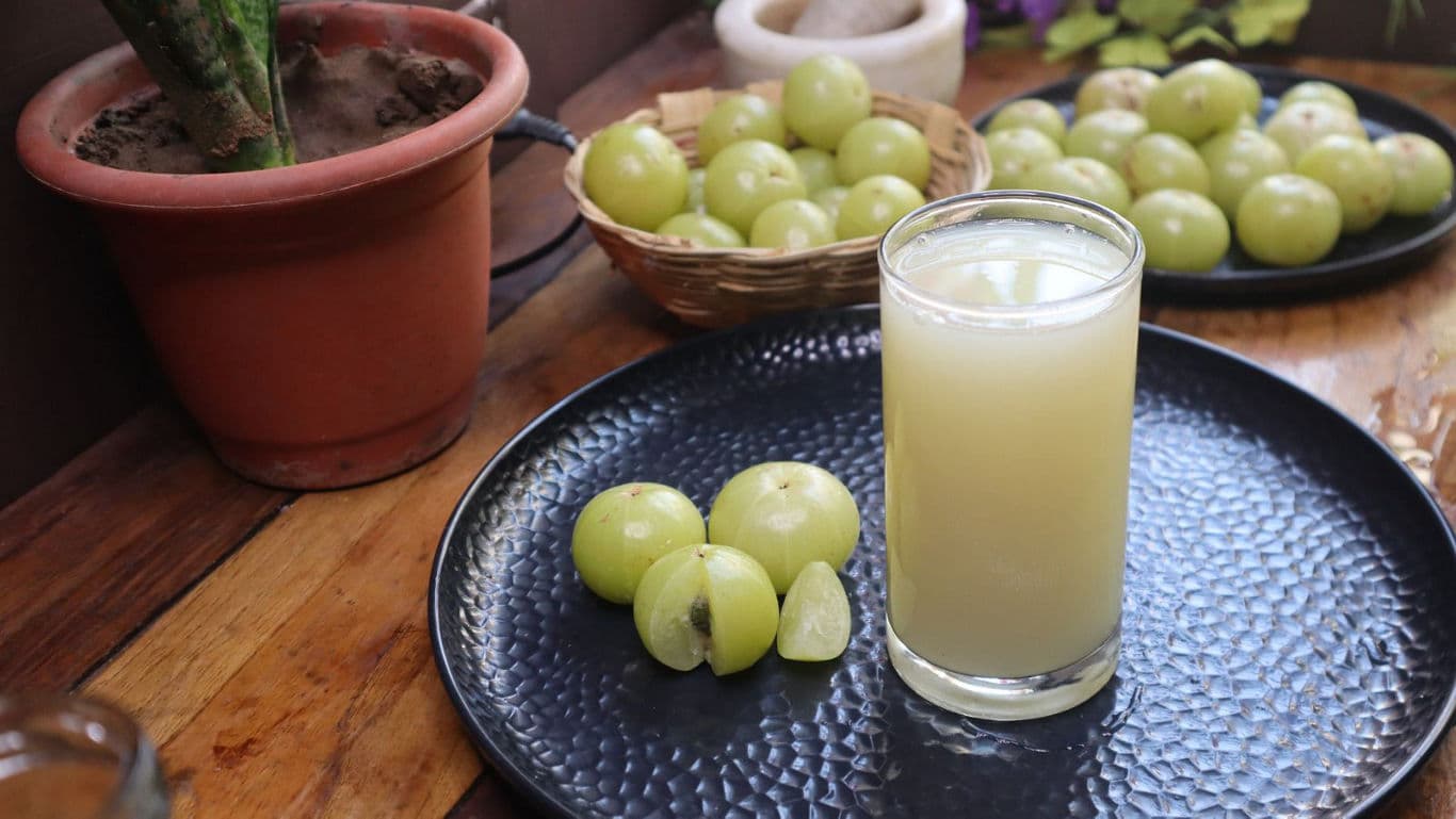 Fresh amla juice with whole fruits