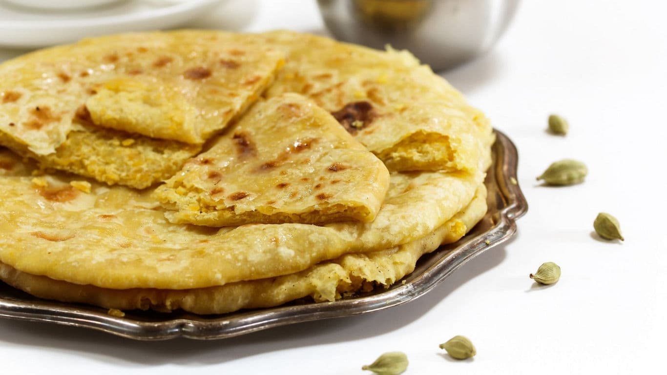 Stuffed Indian flatbread on metal plate
