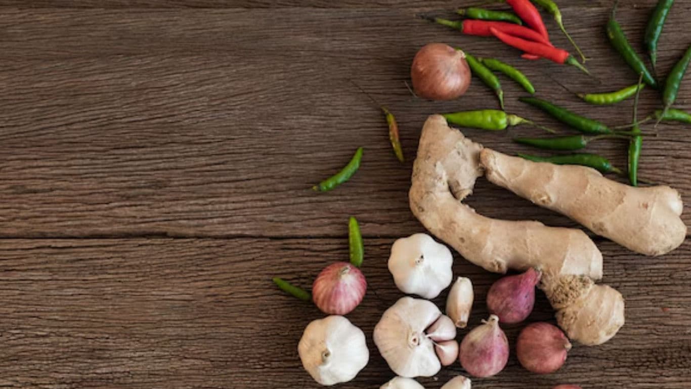 Fresh ginger, garlic, chili and shallots on wood