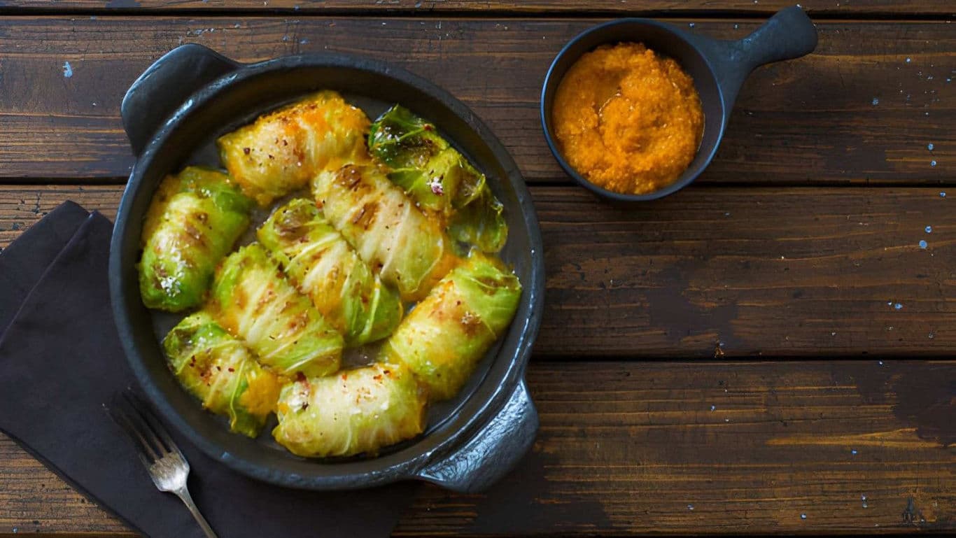 Stuffed cabbage rolls served in rustic black dish