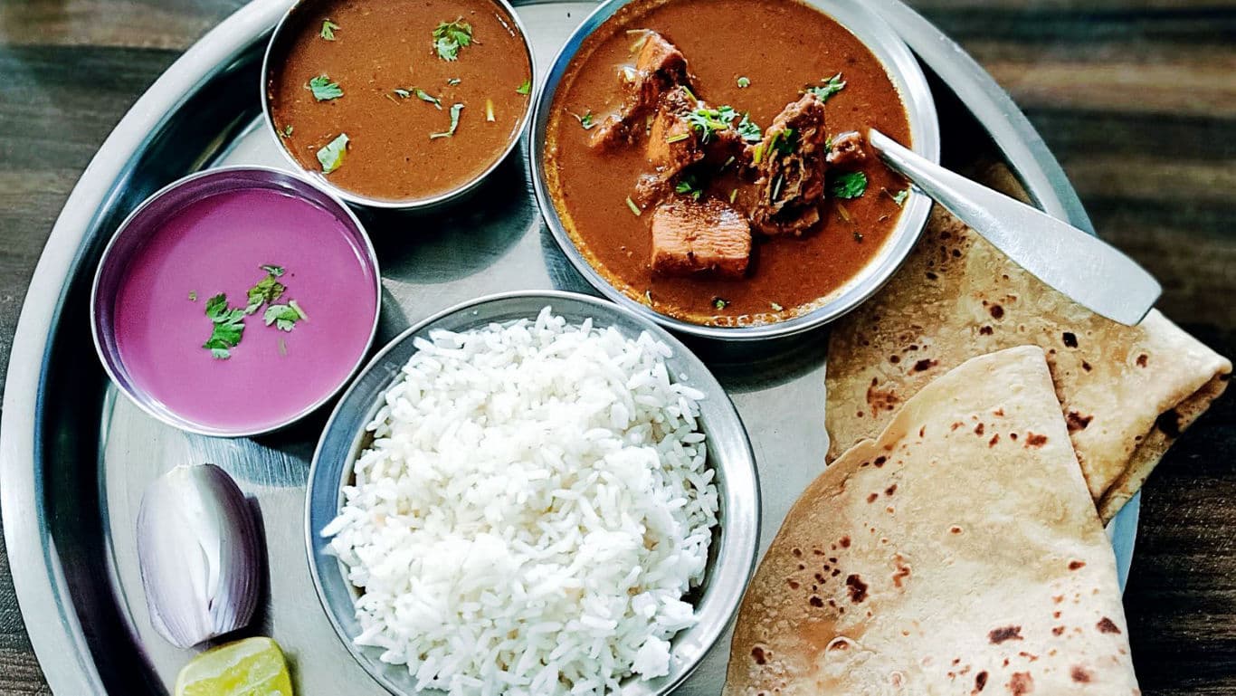 Traditional Indian Thali with Rice, Curry, and Roti