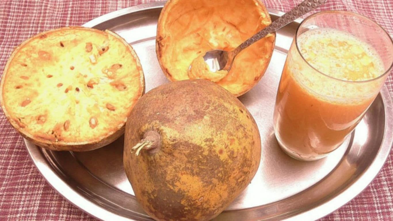 Fresh bael fruit and juice on tray