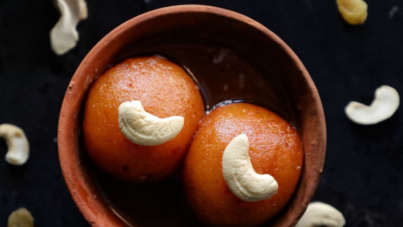 Traditional Indian sweet gulab jamun with cashews