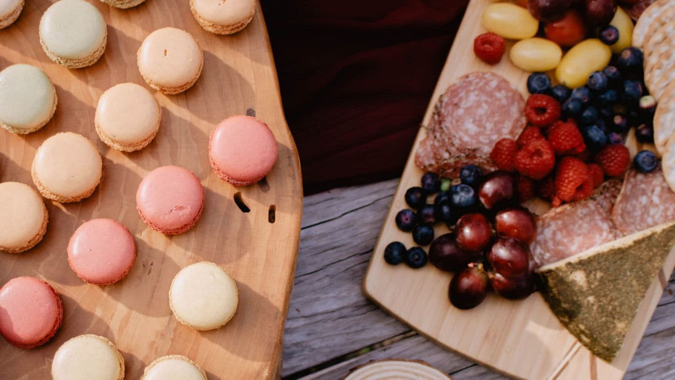 Colorful macarons and charcuterie picnic spread