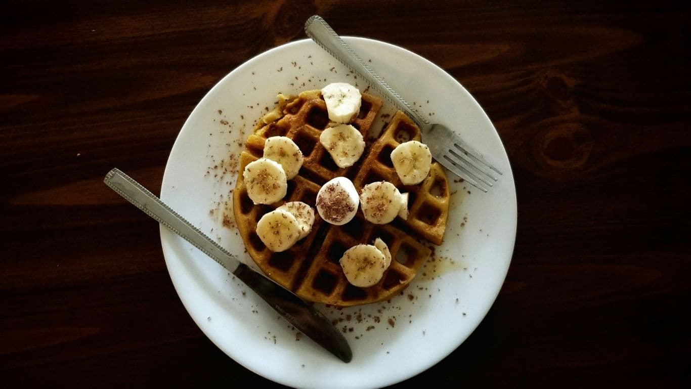 Banana waffle breakfast on white plate