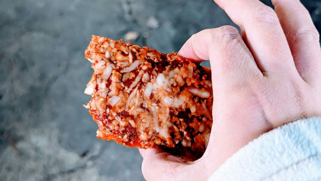 Hand Holding Savory Rice Snack Bar Close-Up