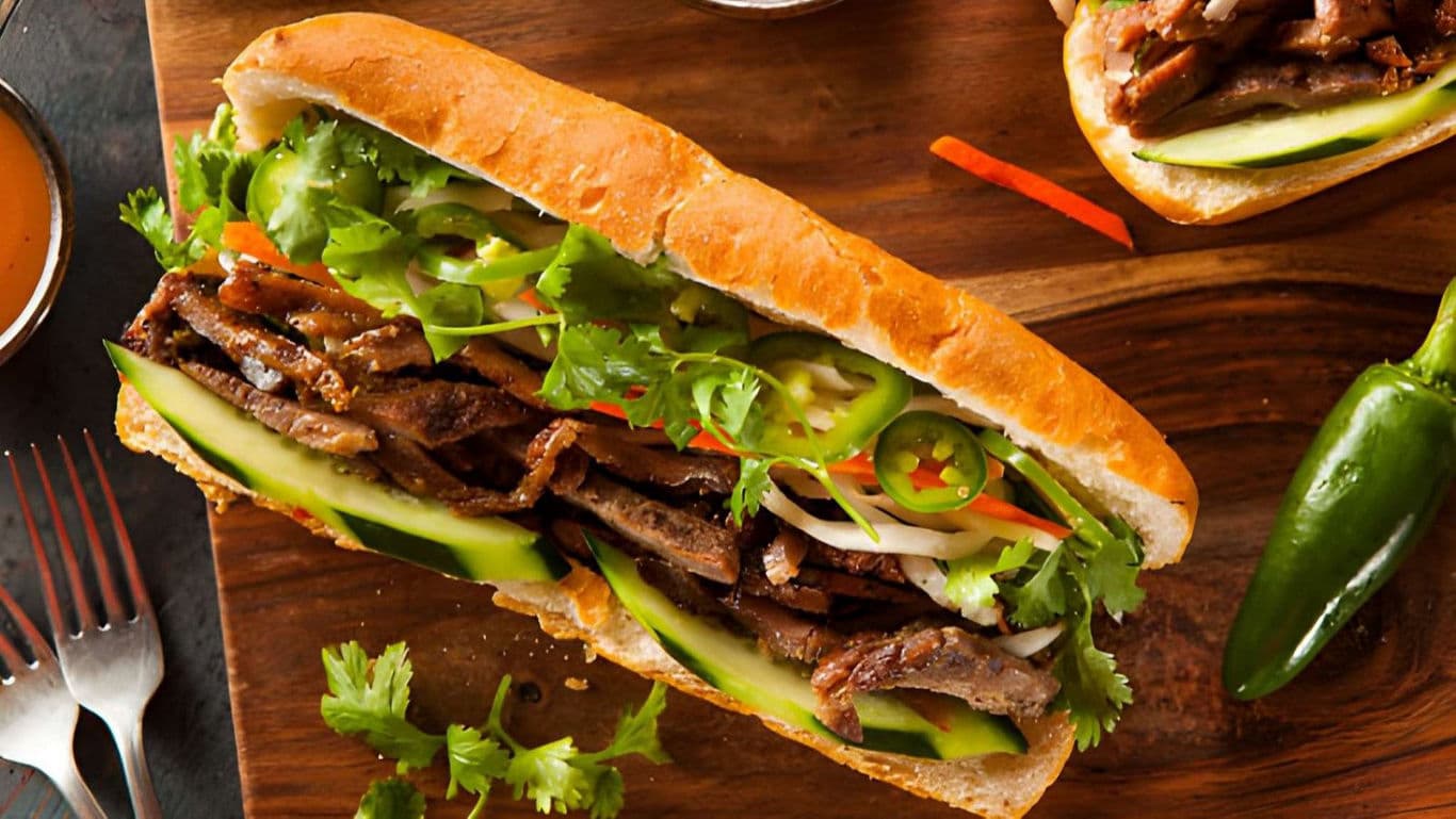 Vietnamese banh mi sandwich with grilled beef and vegetables