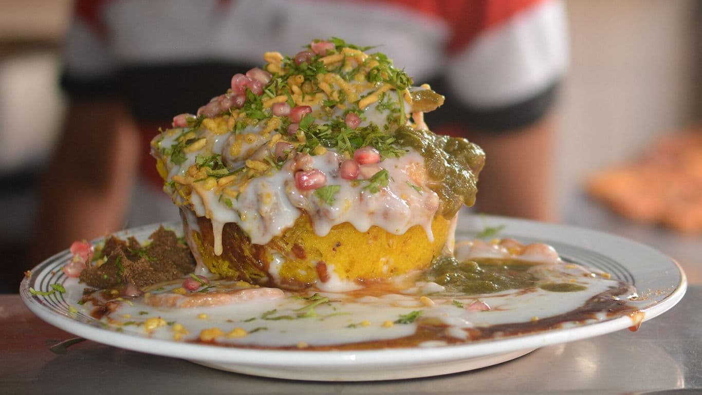 Indian street food dahi bhalla with chutneys and toppings