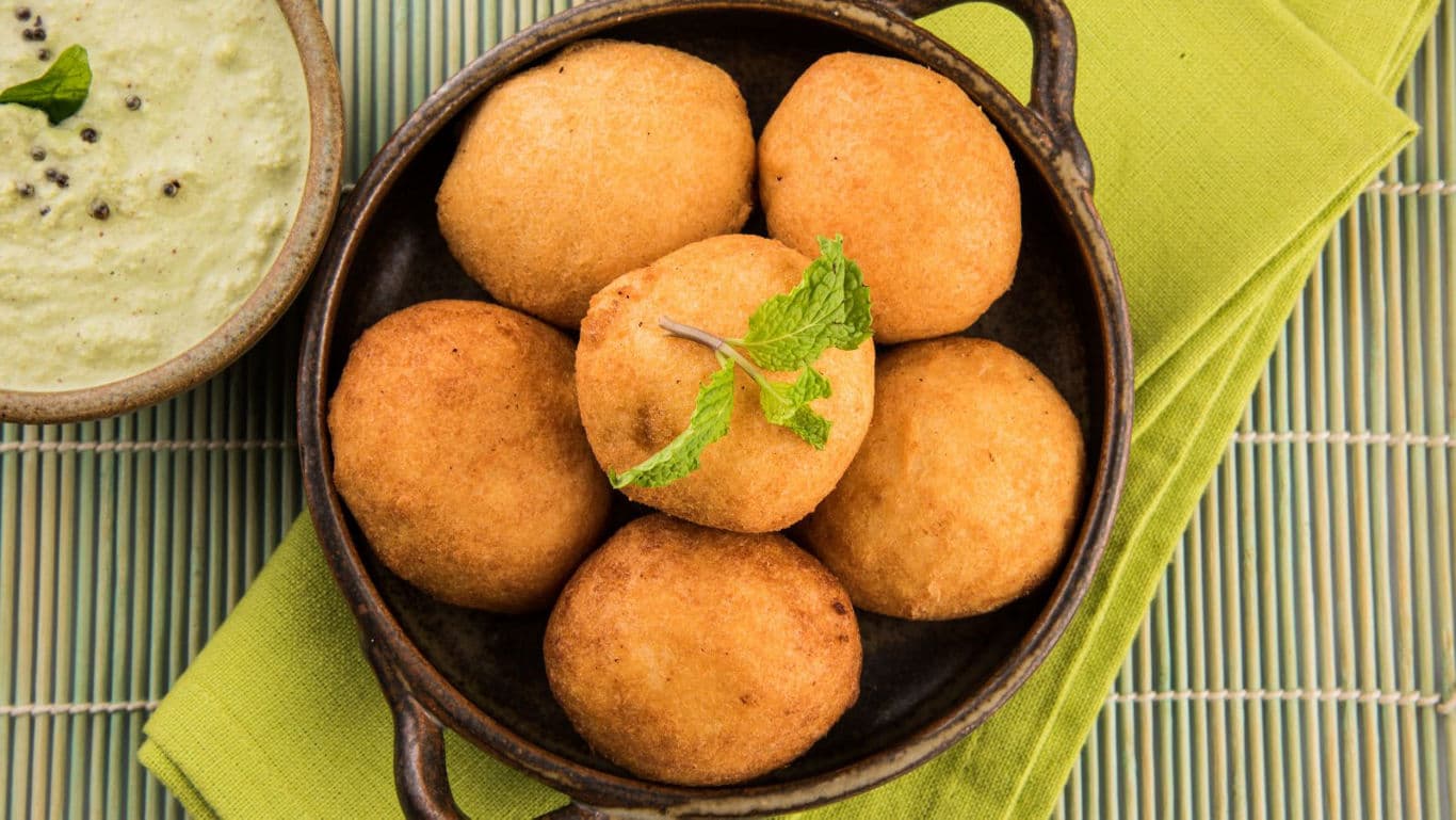Golden fried snacks served with green chutney