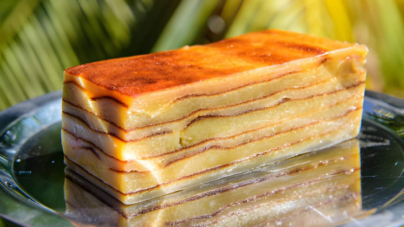 Layered cake dessert on reflective surface