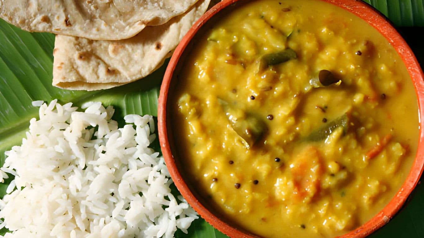 Traditional Indian Dal with Rice and Roti on Banana Leaf