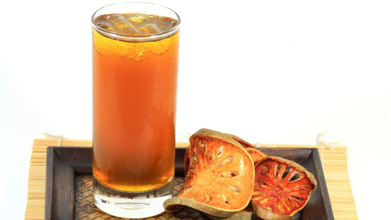Iced herbal bael fruit tea on tray