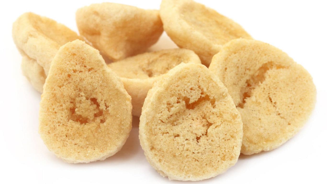Pile of dried bread rusks on white
