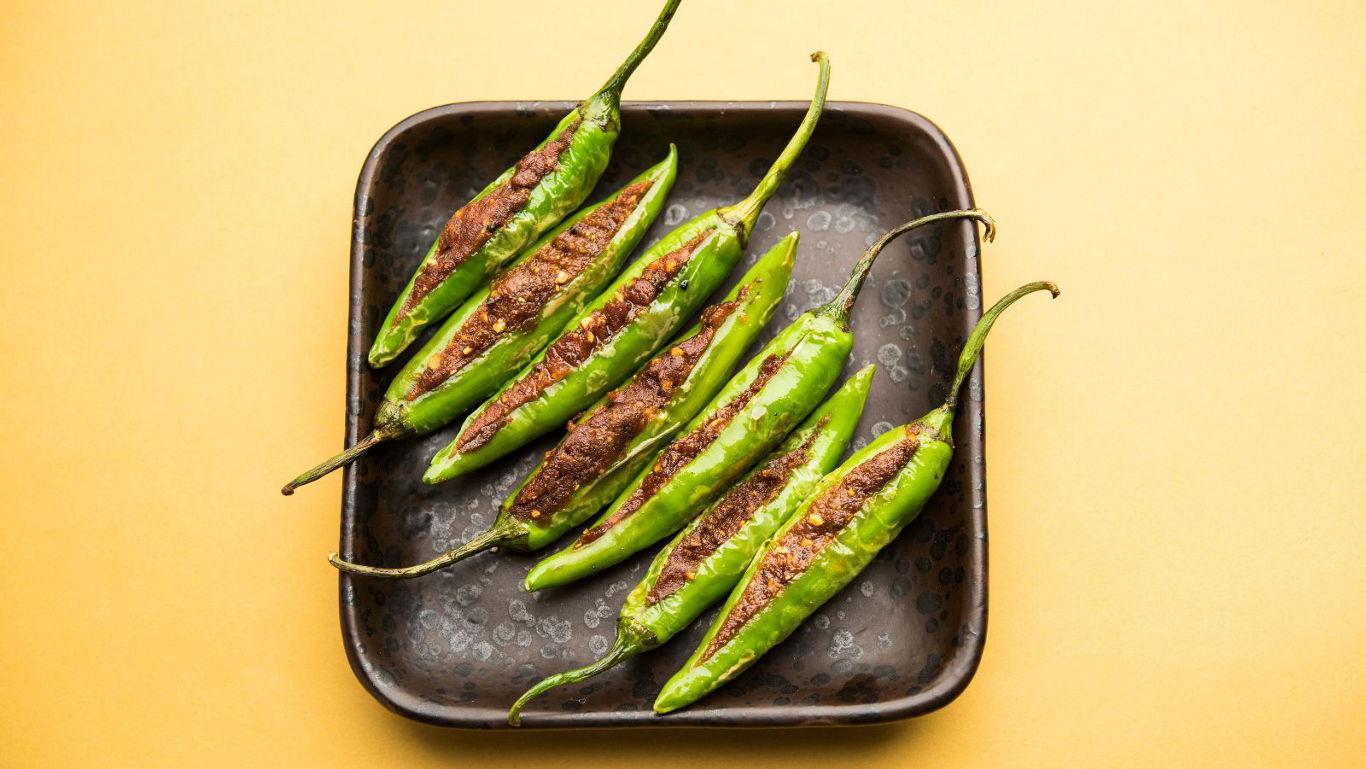 Grilled stuffed green chilies on ceramic plate