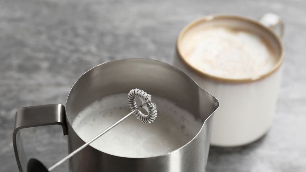 handheld milk frother with coffee cup