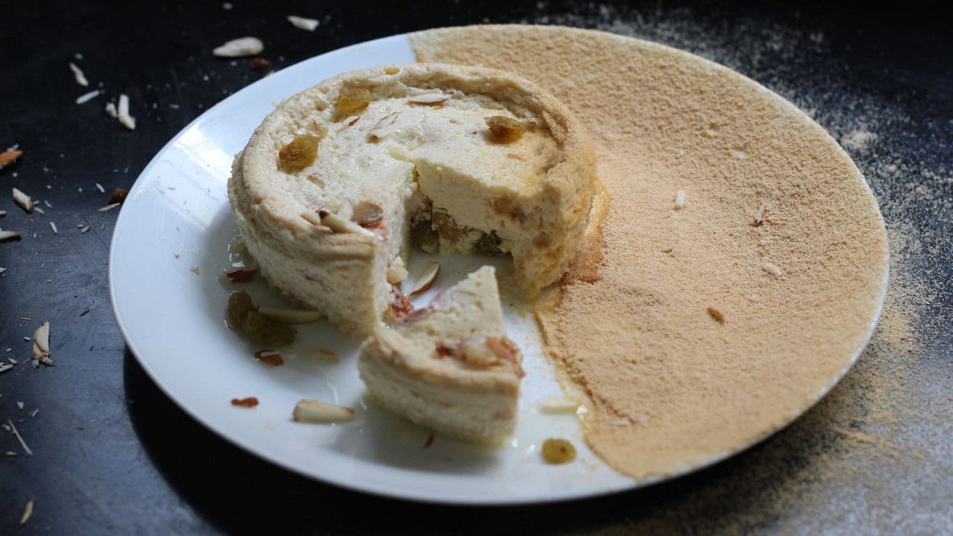 Creamy Indian dessert cake with slice removed