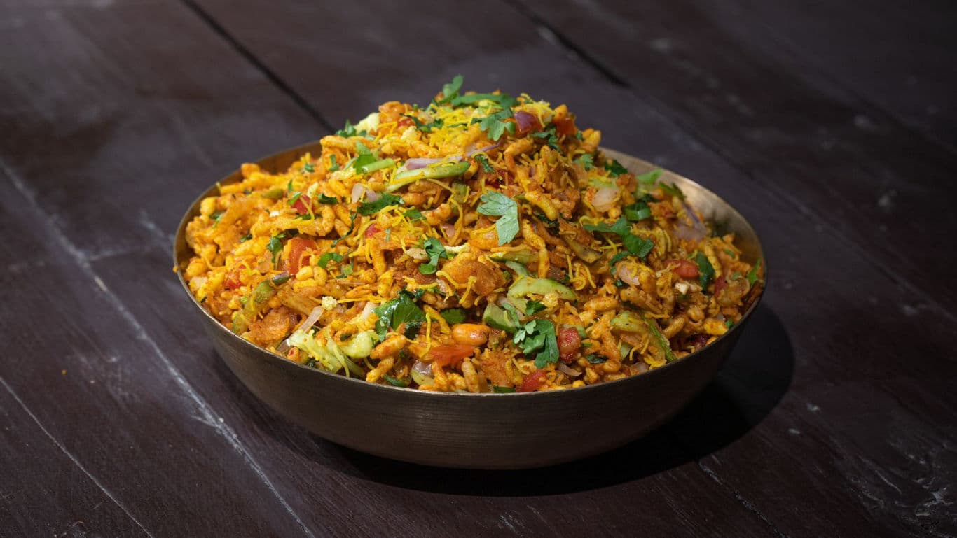 Spicy Indian bhel chaat in metal bowl