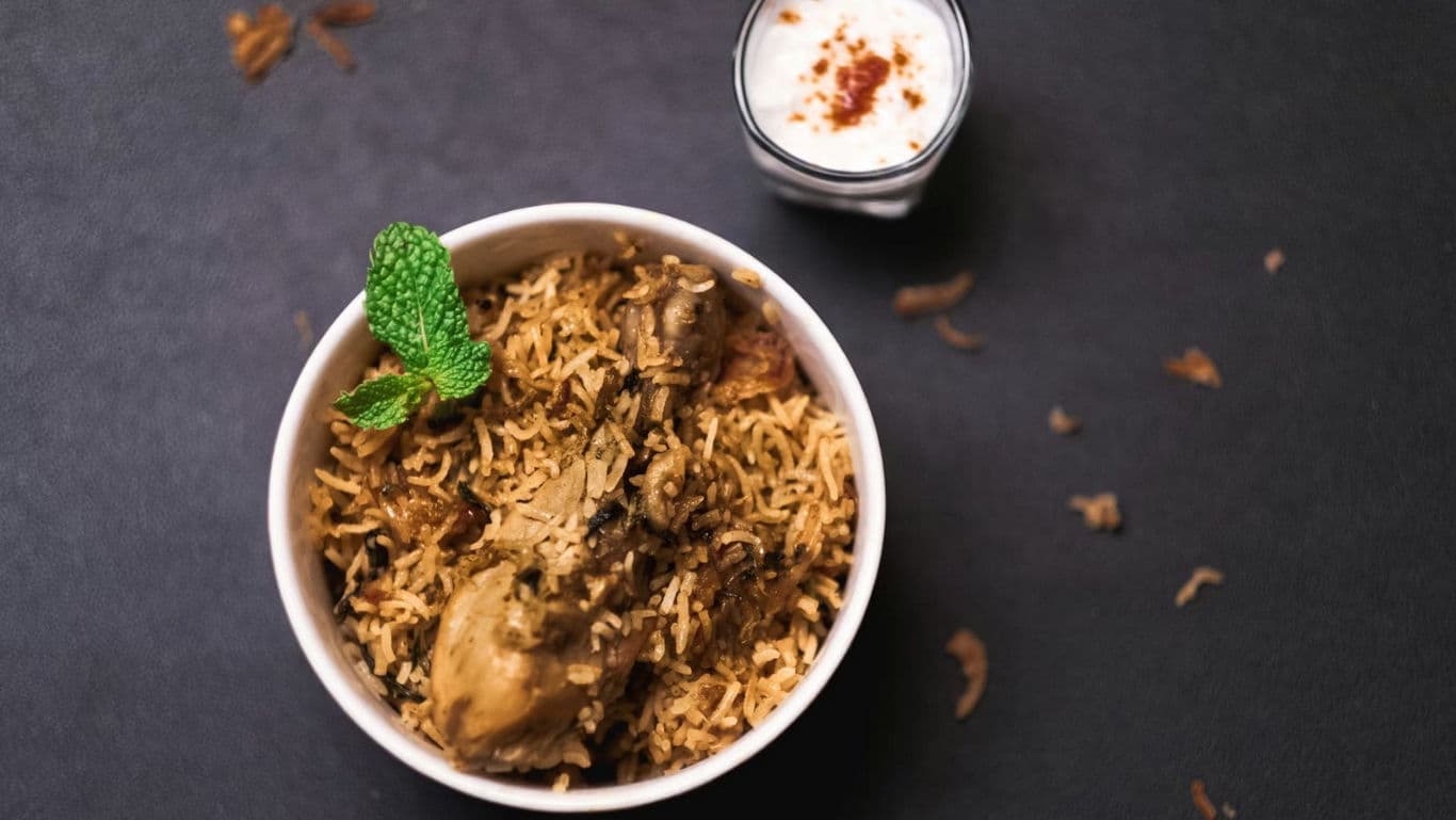 Chicken biryani with yogurt side dish