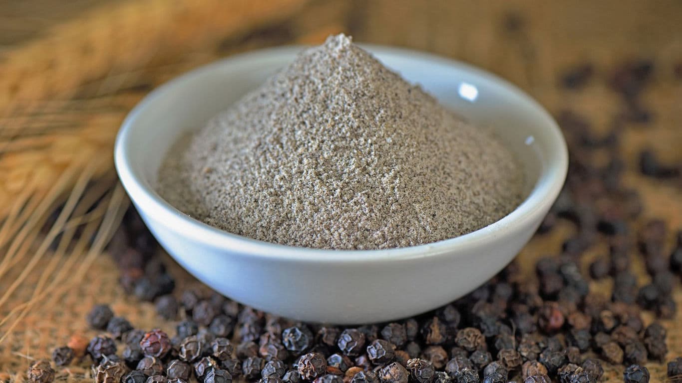 White bowl filled with ground black pepper