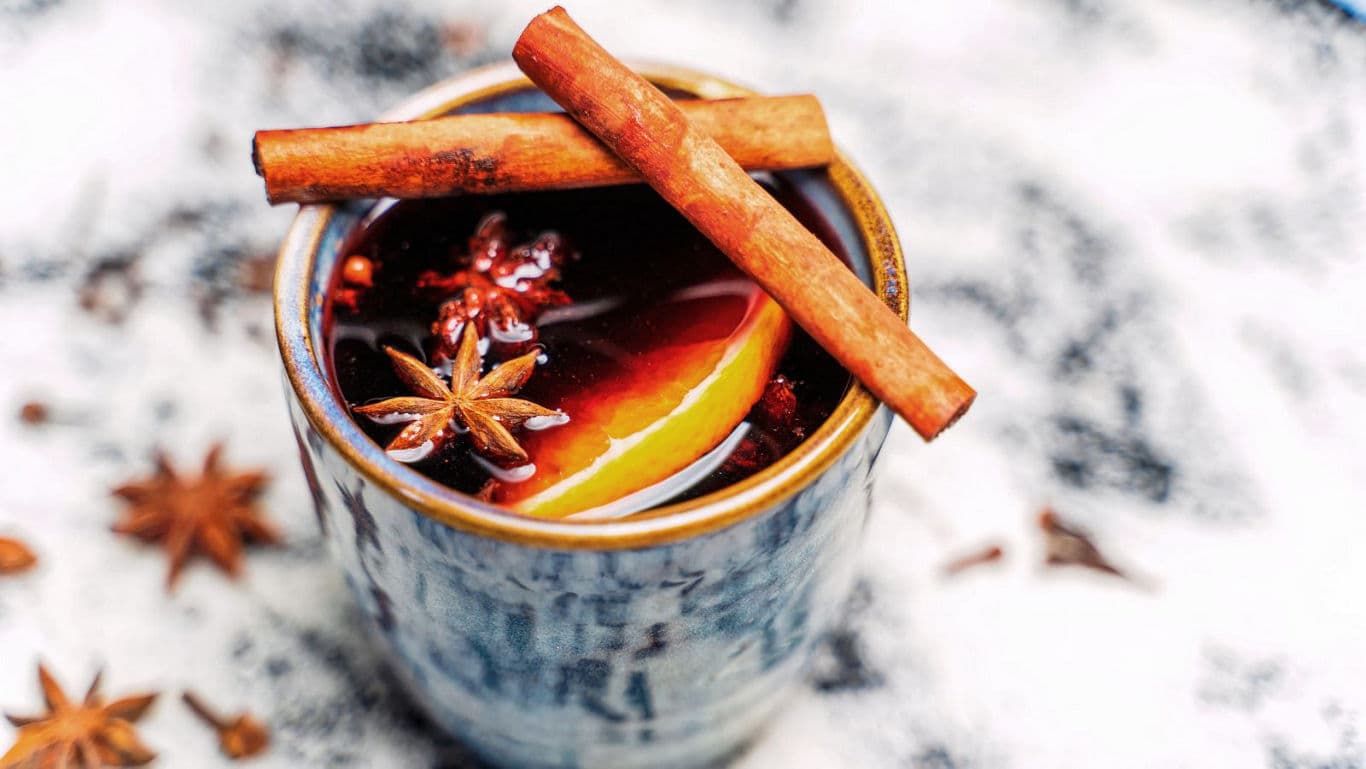 Warm spiced drink with cinnamon sticks