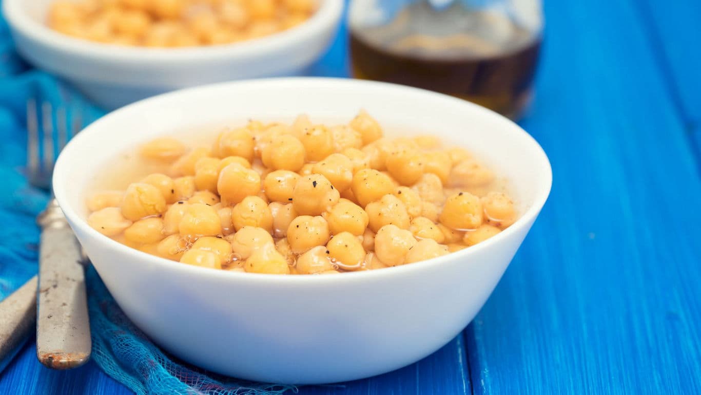 Bowl of Cooked Chickpeas on Blue Table