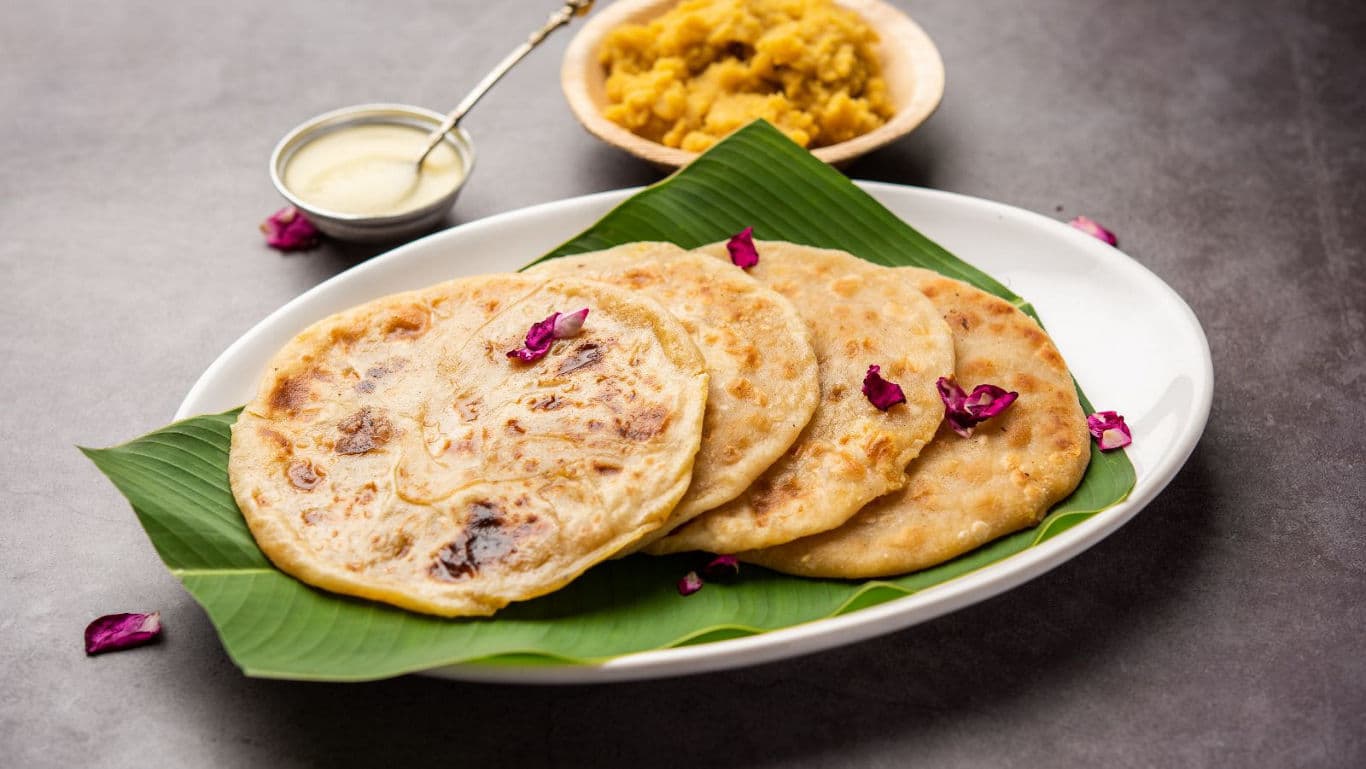 Indian sweet paratha served on banana leaf platter