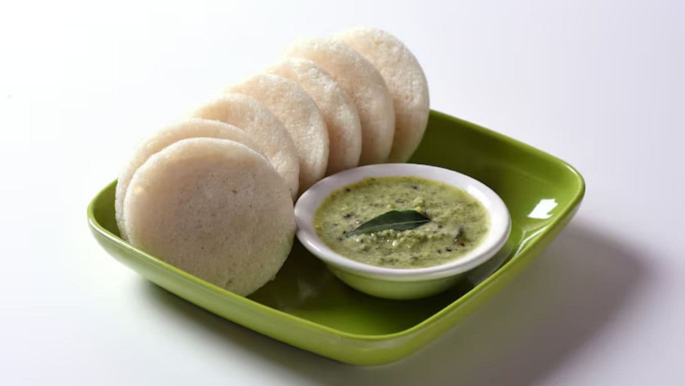 South Indian idli with coconut chutney on green plate