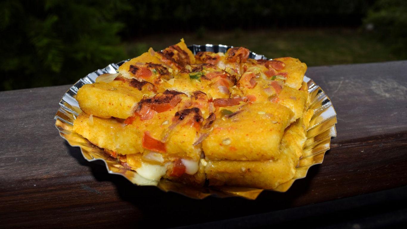 Crispy fried snack with toppings outdoors