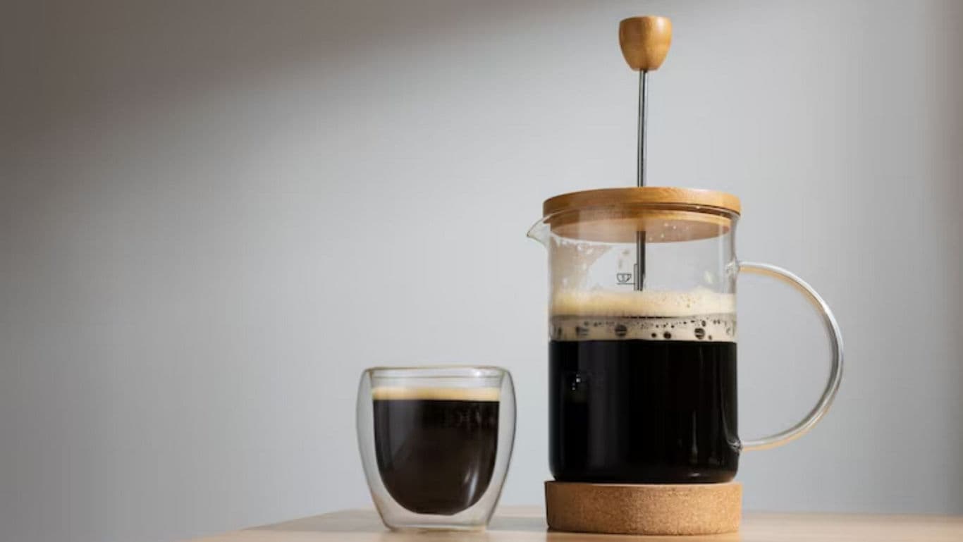 French press with brewed coffee on table