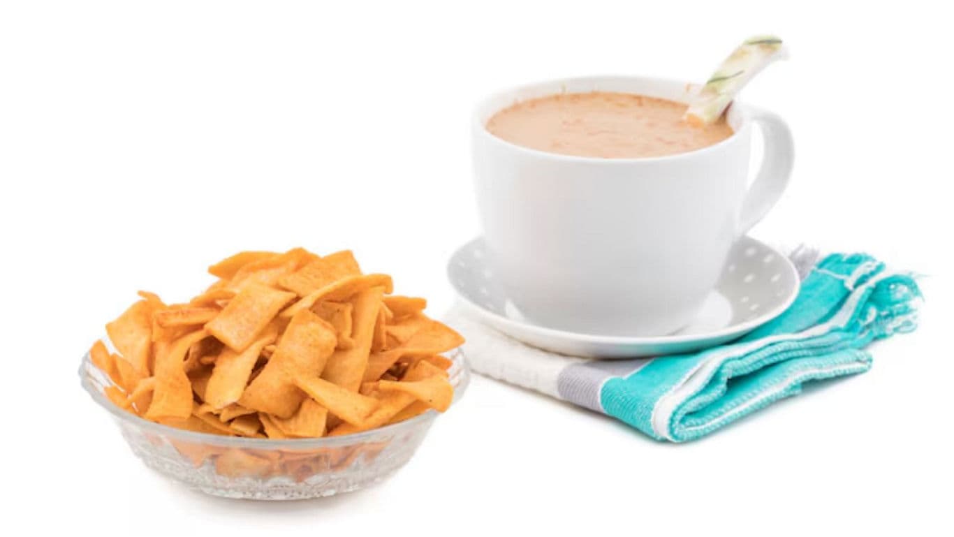 Hot beverage with crispy snack on white background