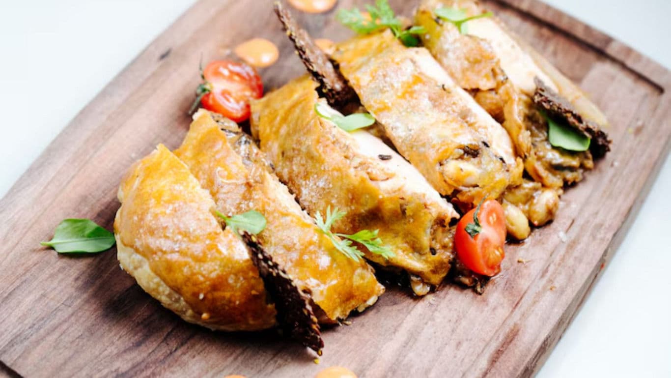 Golden stuffed pastry with fresh garnish